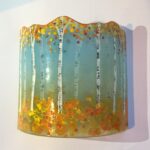 Golden colours of autumn contrasting with cyan background on fused glass panel