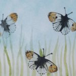 Close up of hand-painted butterfly glass art