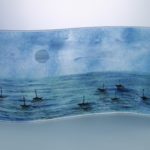 Handpainted fused glass panel with moonlit sea and silhouettes of tiny boats