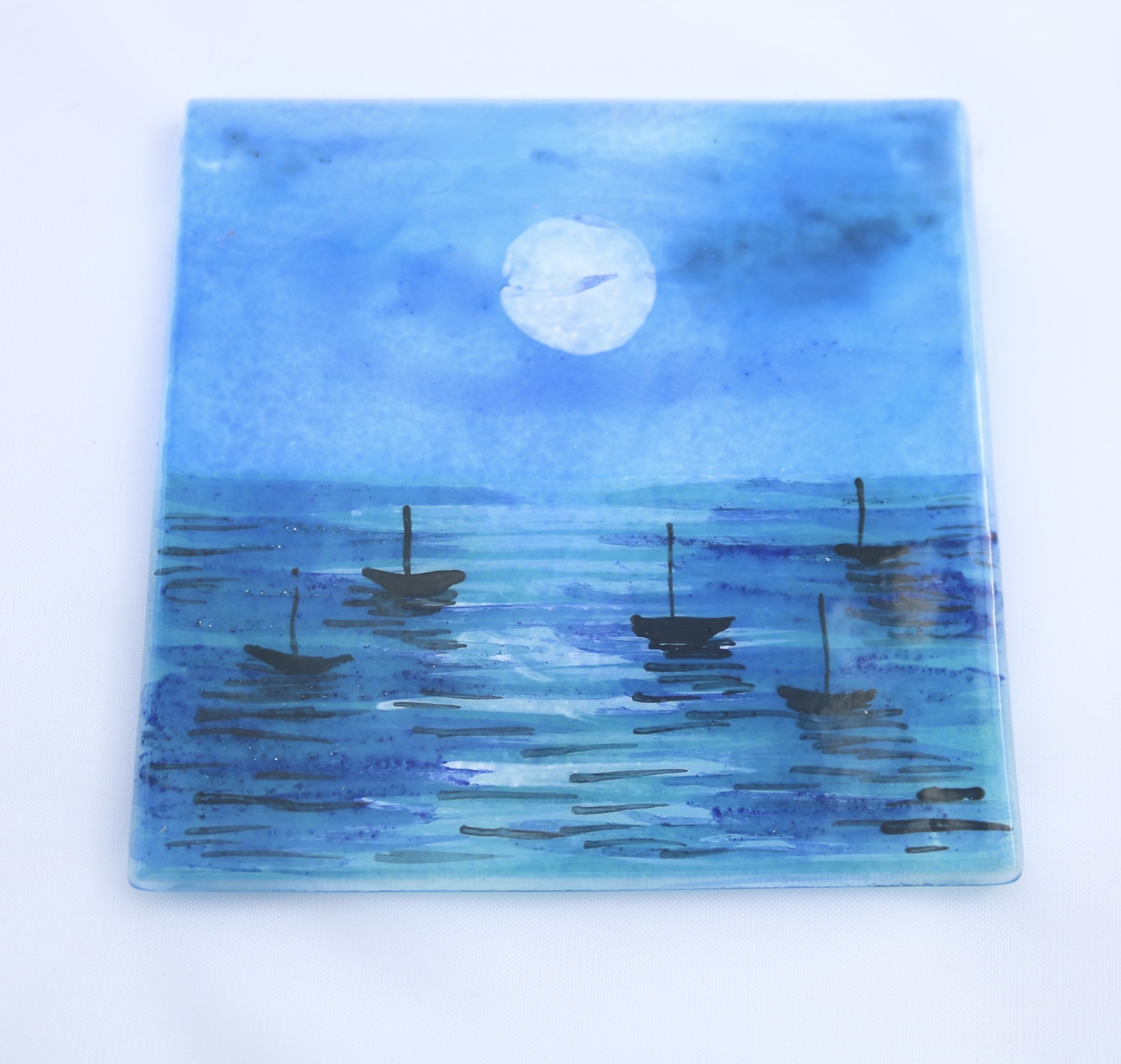 Moonlit sea coaster Fused glass coaster with moon lit sea and silhouettes of boats.